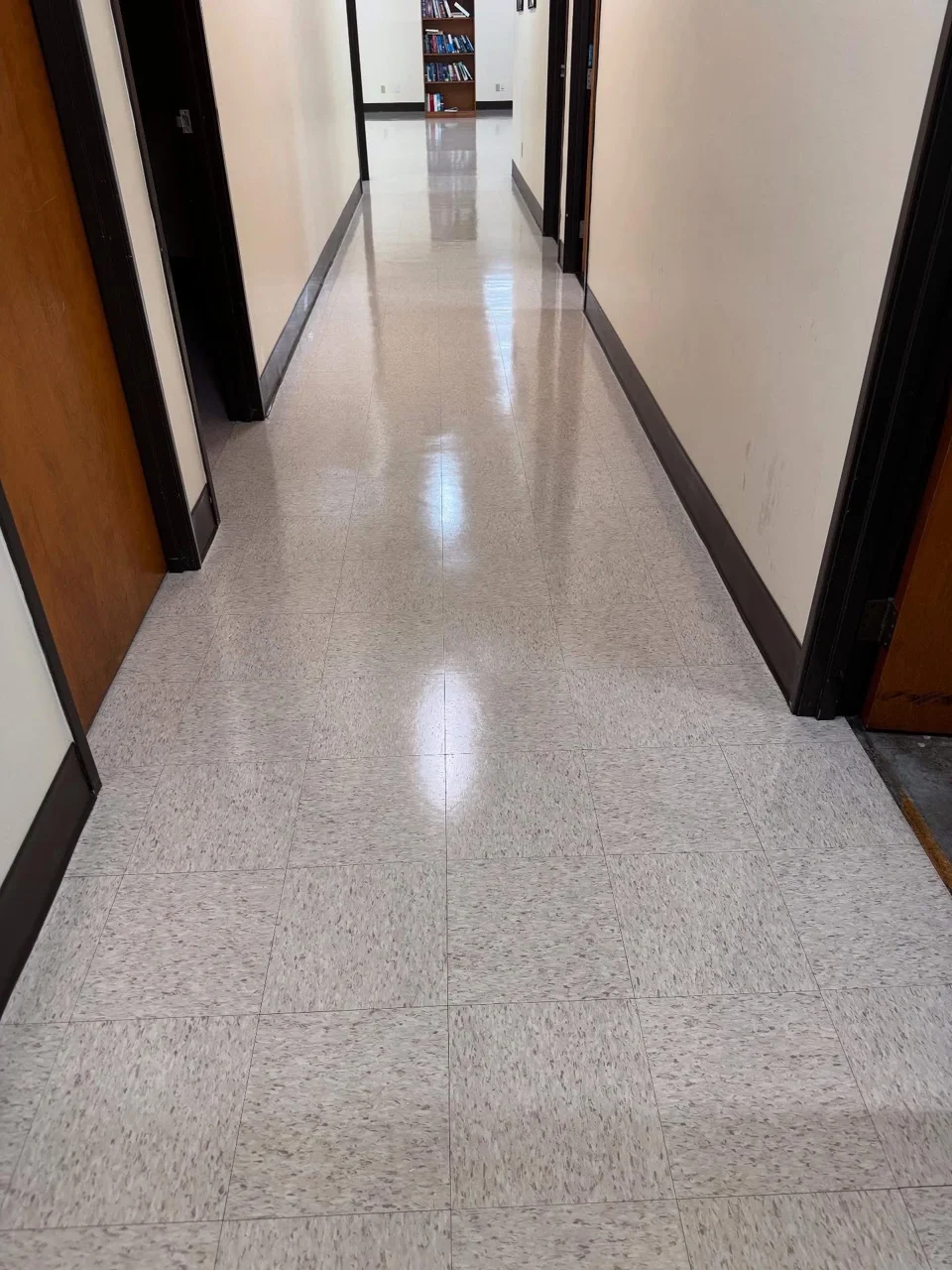 Anaheim office corridor VCT floor after stripping and waxing, reflecting the length of the hallway