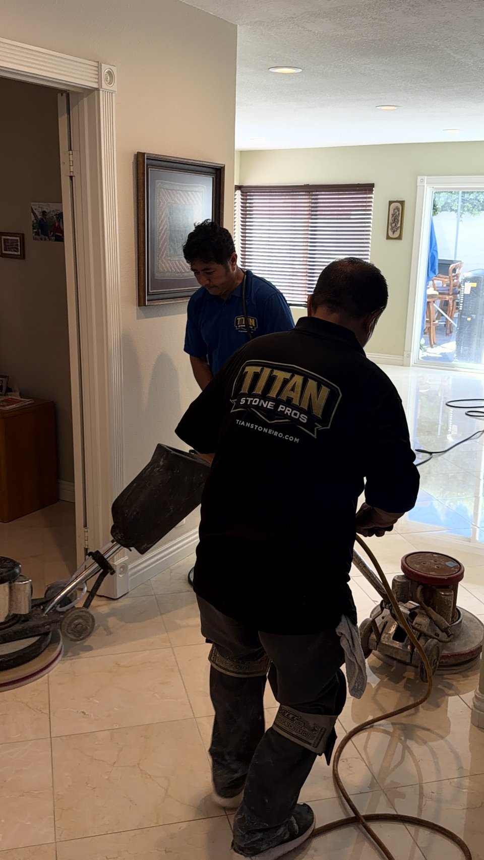 Two Titan Stone Pros technicians honing a marble floor with rotary machines
