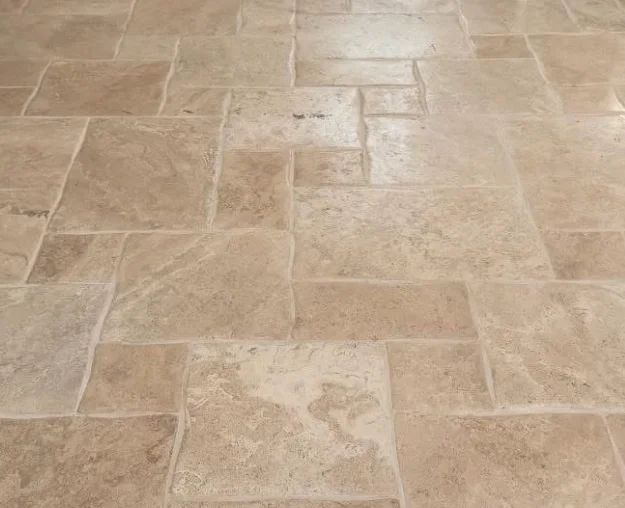 Travertine tile floor with a restored, even finish