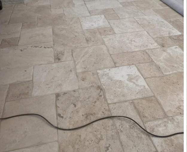 The same travertine tile floor before restoration