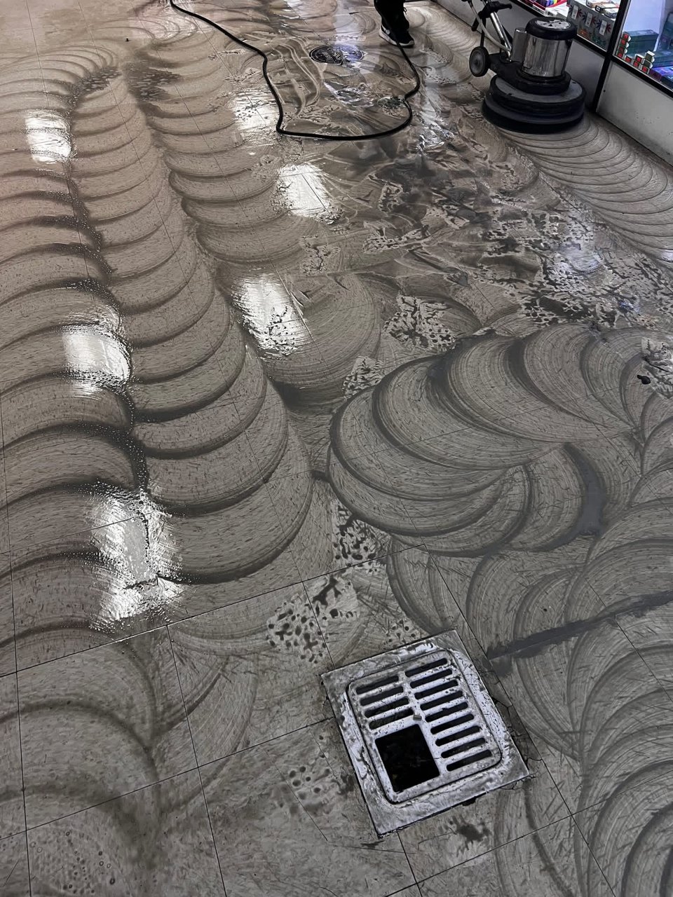 Commercial VCT floor being machine-scrubbed by Titan Stone Pros