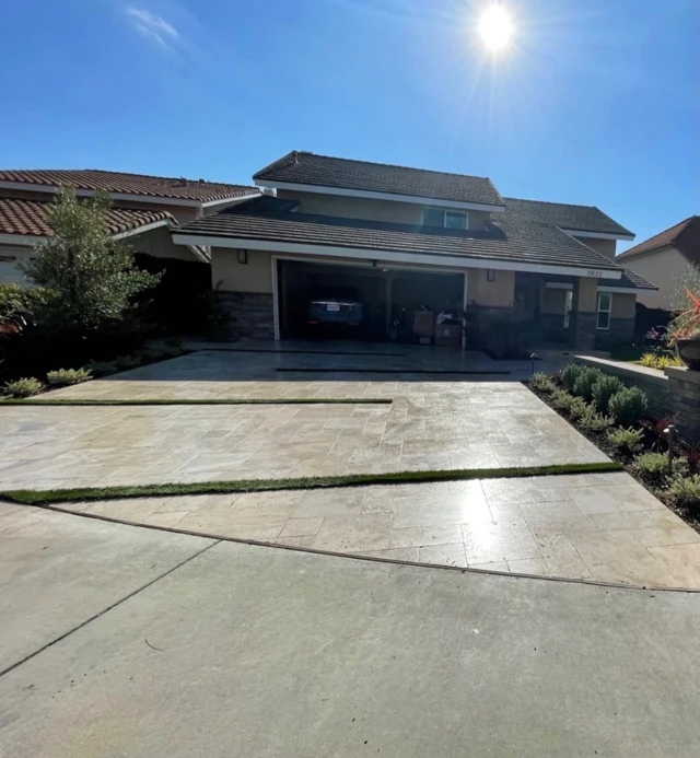 Travertine paver driveway after cleaning, dry and evenly bright in full sun