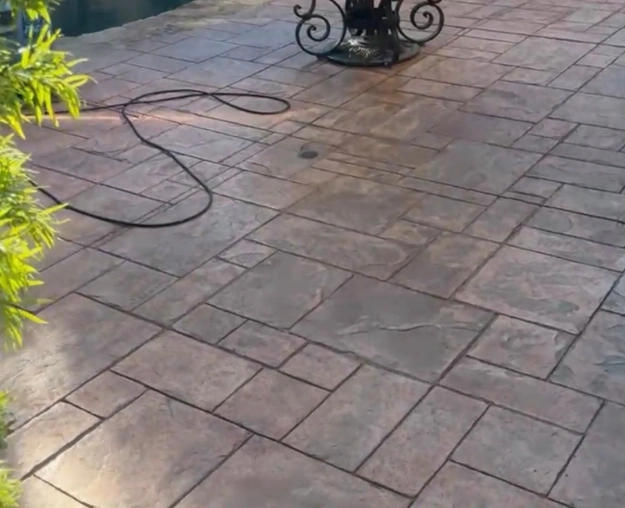Stamped-concrete patio with renewed color after cleaning and staining
