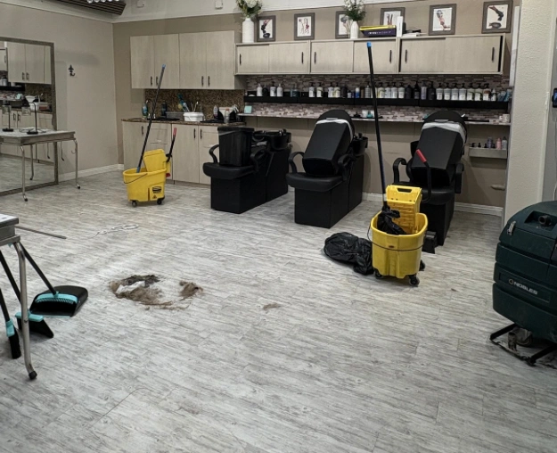 Salon floor with dirt and cleaning equipment