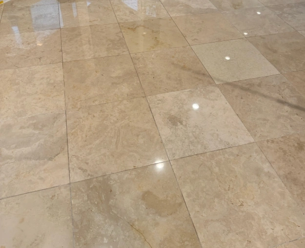 Clean stone tile floor with a reflective finish